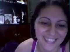 The elderly, dark-haired, smiling webcam nympho displayed her enormous rack.